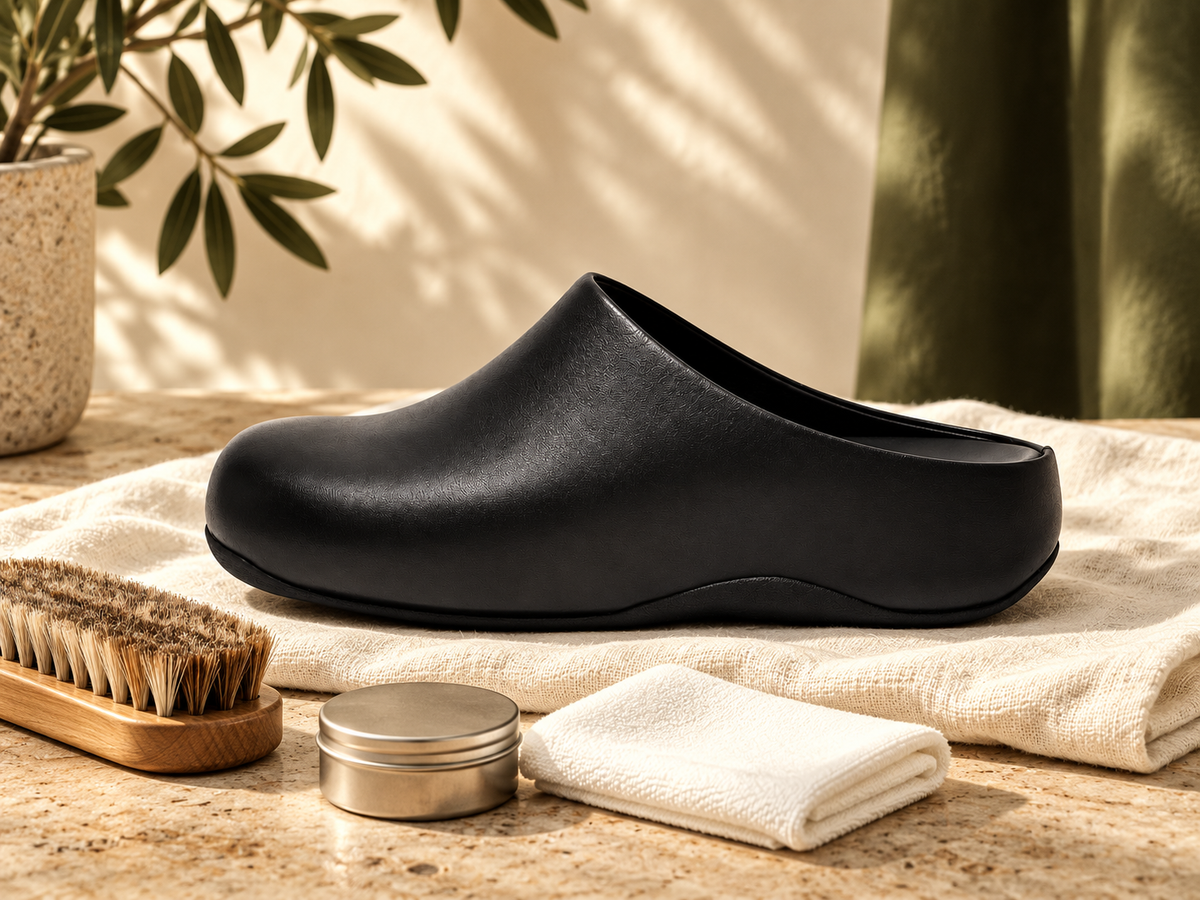 Black leather clog with a soft shoe brush and clean cloths
